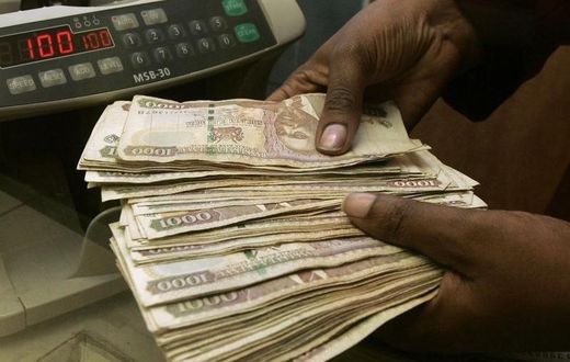 A currency dealer counts Kenya shillings at a money exchange counter in Nairobi October 23, 2008.  REUTERS/Antony Njuguna (KENYA)