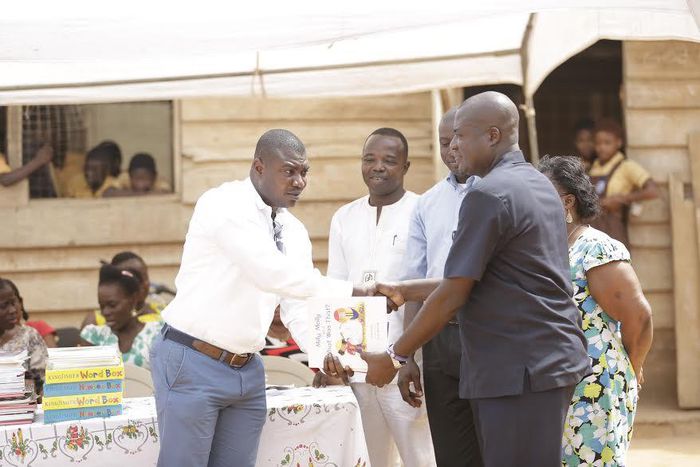 Sam Sarpong (Left) Sales & Distribution Director –Airtel Ghana handing over the books to Mr. Noah Ayisi (Right), Headmaster of the school