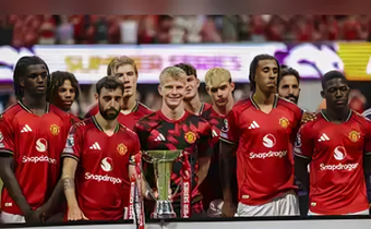 Manchester United players pose with the Summer Series trophy after a Premier League Summer Series soccer match against Everton, Sunday, Aug. 3, 2025 in Atlanta. (AP Photo/Colin Hubbard