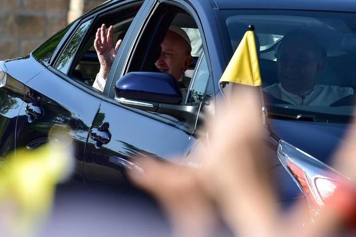 Pope Francis waves to pilgrims from his car, as he leaves the nunciature in Panama City and heads to Las Garzas youth detention center in Pacora, on the outskirts of the capital