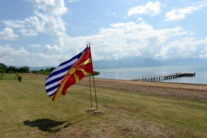 The flags of Greece and Macedonia flutter on the shores of Lake Prespa where last June's historic name deal was signed