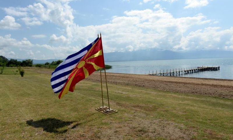 The flags of Greece and Macedonia flutter on the shores of Lake Prespa where last June's historic name deal was signed