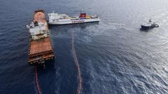 In this file photo taken on October 10, 2018 the French navy ocean tug L'Abeille Flandre (R) approaches two cargo ships - the Tunisian freighter Ulysse (C) and Cyprus-based vessel anchored CLS Virginia (L) - after they collided north of Corsica