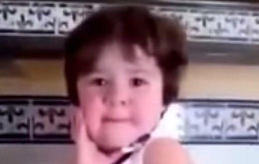 Crying baby girl immediately strikes a pose as soon as she sees a camera