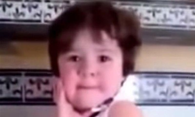 Crying baby girl immediately strikes a pose as soon as she sees a camera