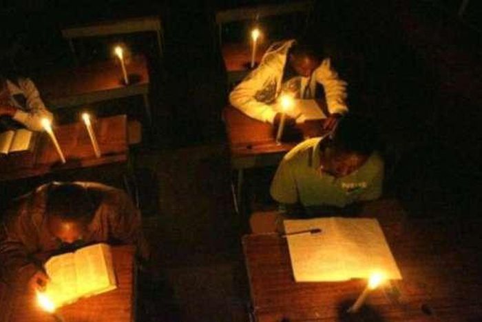 Students learning with candle