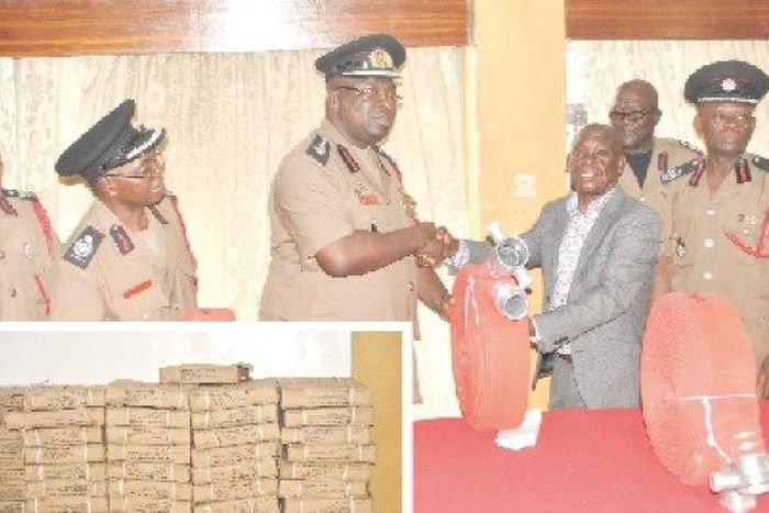 Mr Francis Owusu Ansah (in suit), CEO of Tohaba Limited, presenting the items to Dr Albert Brown Gaisie (4th left), Chief Fire Officer