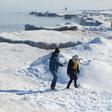 People walk along Lake Michigan's frozen shoreline as temperatures dropped to -20 degrees F (-29C) Chicago