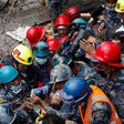 A teenager is carried on a stretcher after being rescued by Nepalese policemen and U.S. rescue workers from a building that collapsed five days after the devastating Earthquake.