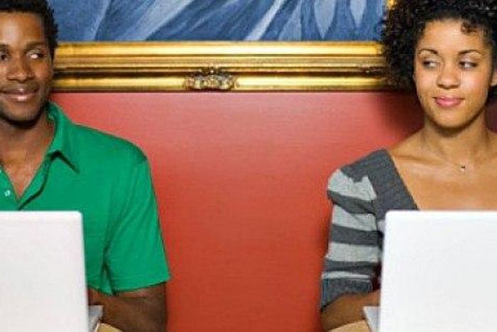 Couple using laptops