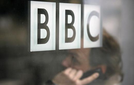 A man talks on a mobile phone inside the BBC headquarters in London November 21, 2008. REUTERS/Andrew Winning