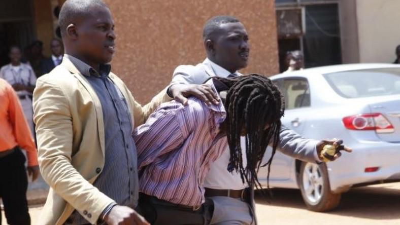 Gregory Afoko (Head bowed)