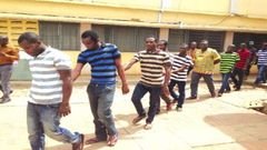 The accused persons being taken away from the court