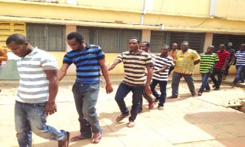 The accused persons being taken away from the court