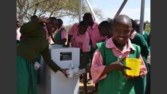 Kenyan school children making use of the ATM-like water solutions
