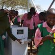 Kenyan school children making use of the ATM-like water solutions