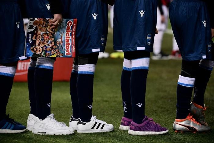 A child holds the Serie A new Panini sticker album prior to an Italian league match.