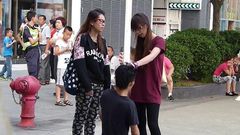 A Chinese woman has been arrested after forcing her boyfriend to kneel in the street and repeatedly slapping him around the face.