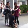 A Chinese woman has been arrested after forcing her boyfriend to kneel in the street and repeatedly slapping him around the face.