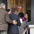 (FILES) In this file photo taken on December 12, 2018 Meng Wanzhou (R), Chief Financial Officer of Huawei Technologies, answers the door for individuals carrying flowers after she was released on bail in Vancouver, British Columbia on December 12, 2018...