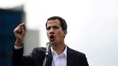 Venezuela's National Assembly head Juan Guaido speaks to the crowd during a mass opposition rally against leader Nicolas Maduro in which he declared himself the country's "acting president"