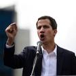 Venezuela's National Assembly head Juan Guaido speaks to the crowd during a mass opposition rally against leader Nicolas Maduro in which he declared himself the country's "acting president"