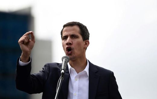 Venezuela's National Assembly head Juan Guaido speaks to the crowd during a mass opposition rally against leader Nicolas Maduro in which he declared himself the country's "acting president"