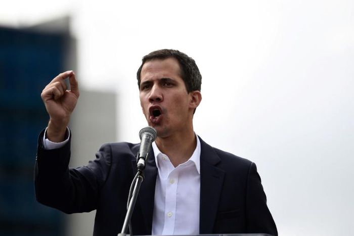 Venezuela's National Assembly head Juan Guaido speaks to the crowd during a mass opposition rally against leader Nicolas Maduro in which he declared himself the country's "acting president"