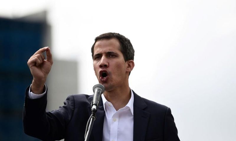Venezuela's National Assembly head Juan Guaido speaks to the crowd during a mass opposition rally against leader Nicolas Maduro in which he declared himself the country's "acting president"