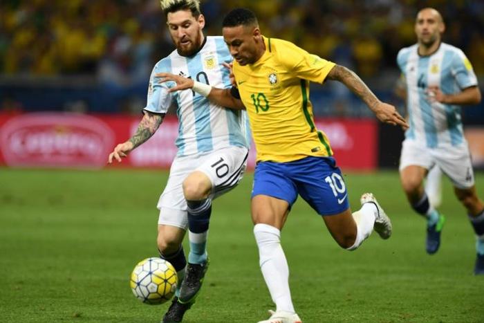 Argentina's Lionel Messi (left) and Brazil's Neymar challenge for the ball in a World Cup qualifier in 2016