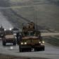 A US military convoy passes the flashpoint Syrian town of Manbij on December 30, 2018, part of a deployment the US-led anti-jihadist coalition says it has now begun withdrawing following a controversial decision by President Donald Trump last month