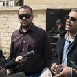 Al Jazeera television journalists Mohamed Fahmy (R) and Baher Mohamed speak to the media outside of a court in Cairo, March 19, 2015. March 19, 2015. REUTERS/Shadi Bushra