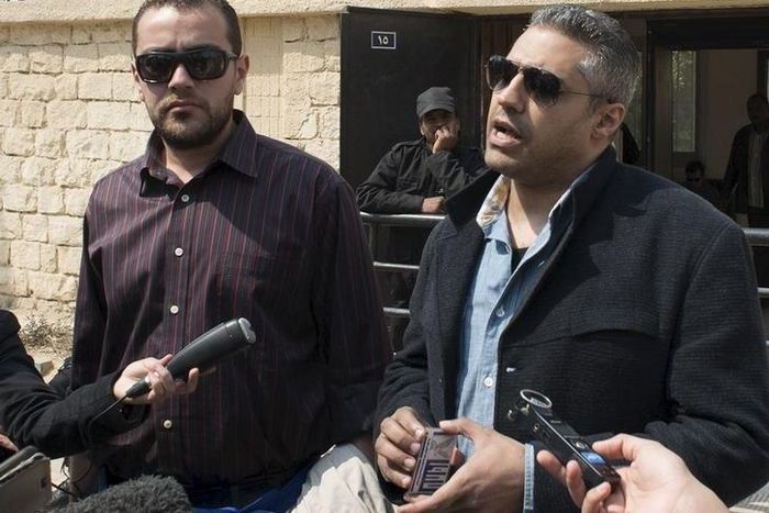 Al Jazeera television journalists Mohamed Fahmy (R) and Baher Mohamed speak to the media outside of a court in Cairo, March 19, 2015. March 19, 2015. REUTERS/Shadi Bushra