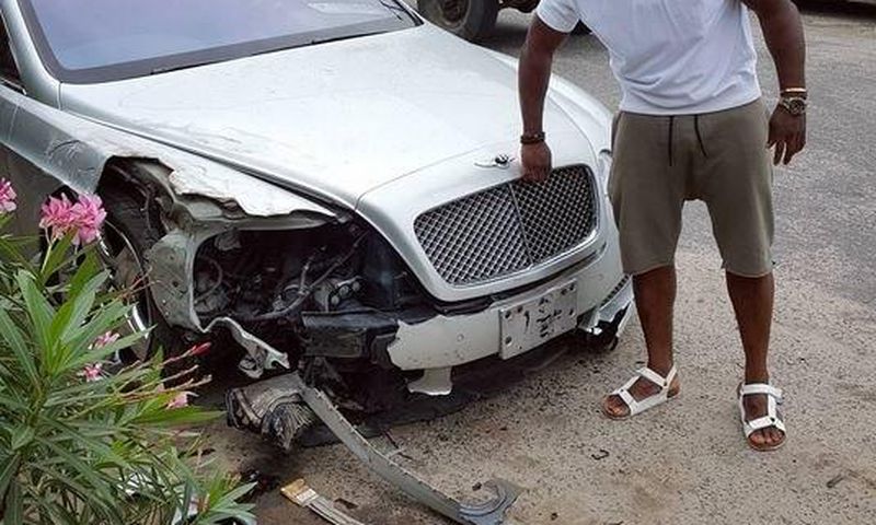 Timaya with his bashed Bentley