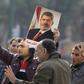 Supporters of the Muslim Brotherhood and ousted Egyptian President Mohamed Mursi hold a copy of the Koran and Mursi's picture at Talaat Harb Square, in Cairo, January 25, 2015. REUTERS/Mohamed Abd El Ghany