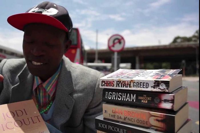 The "Pavement Bookworm" has attracted attention near and far because of his unconventional methods of making money while homeless.