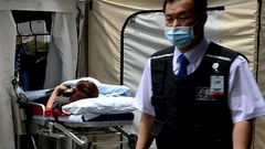 A woman, who is believed to be infected with Middle East Respiratory Syndrome (MERS), lies on a stretcher in a quarantine area set up in a hospital in Seoul, South Korea.