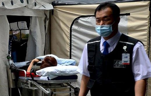A woman, who is believed to be infected with Middle East Respiratory Syndrome (MERS), lies on a stretcher in a quarantine area set up in a hospital in Seoul, South Korea.