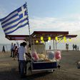 A candy floss stand carrying the Greek national flag.