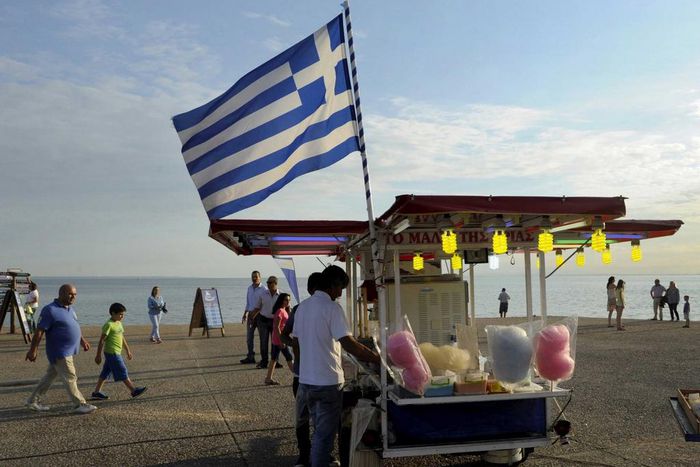 A candy floss stand carrying the Greek national flag.