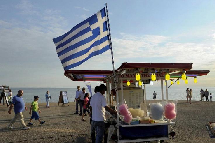A candy floss stand carrying the Greek national flag.
