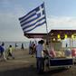 A candy floss stand carrying the Greek national flag.