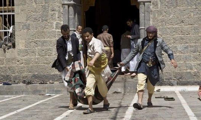 Yemenis carry a body of a man killed in a bomb attack in a mosque in Sanaa, Yemen, Friday, March 20, 2015.