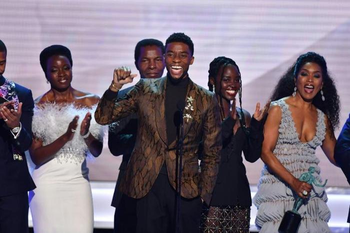 Chadwick Boseman (C) accepts the top SAG Award for "Black Panther" flanked by his castmates including Michael B. Jordan (L), Danai Gurira (C), Lupita Nyong'o (2R) and Angela Bassett (R)