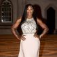 Serena Williams shows of her toned figure in a peach floor length dress