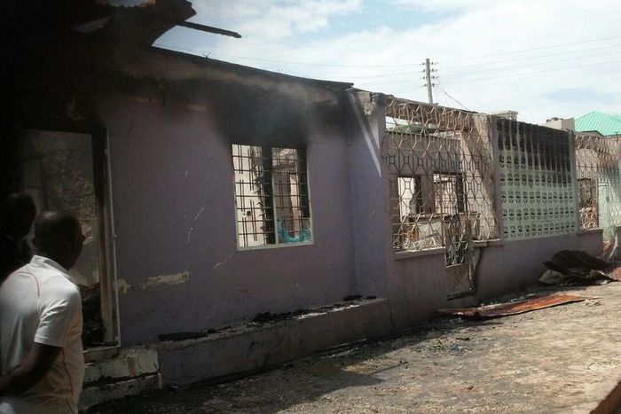 GNFS personnel inspecting the damaged building