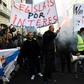 Taxi drivers hold flares and placards reading "Regulation now" during a demonstration in to protest against online ride-sharing services like Uber