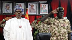 Nigerian president Muhammadu Buhari (L) ordered an end to the newspaper office siege, his spokesman said