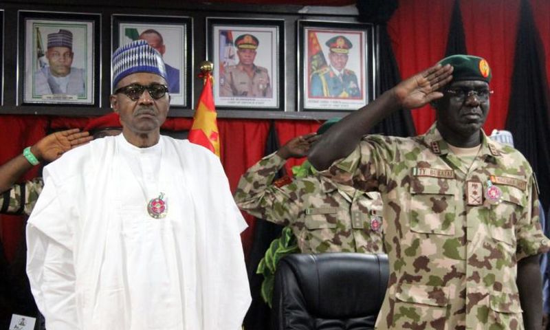 Nigerian president Muhammadu Buhari (L) ordered an end to the newspaper office siege, his spokesman said