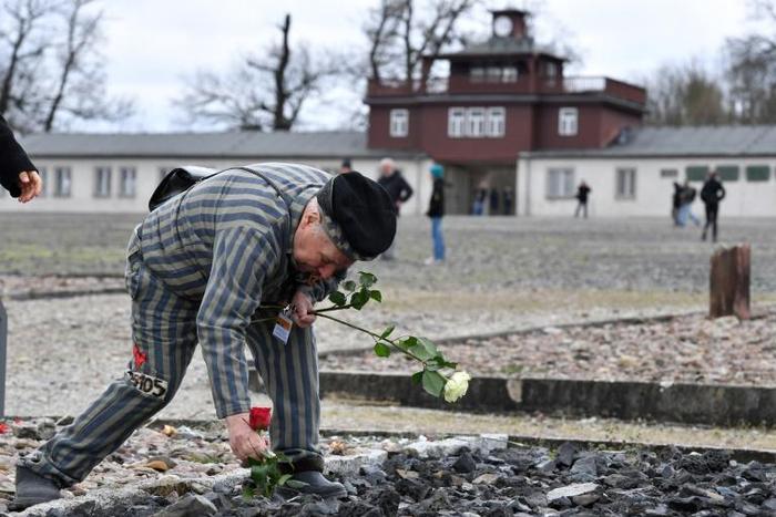 A former prioner lays flowers at the Buchenwald Nazi concentration camp in Weimar, eastern Germany, whose foundation is now protesting plans to turn an annex at the site into a sausage museum